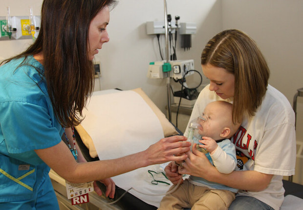 a baby undergoing a breathing treatment