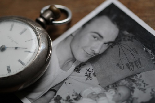 A black and white photograph next to an old pocket watch