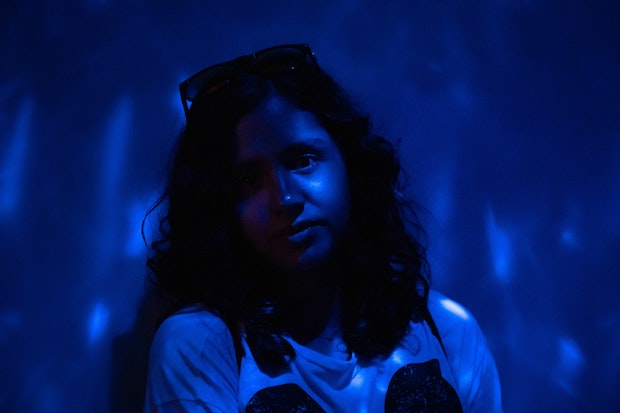 a woman bathed in blue light