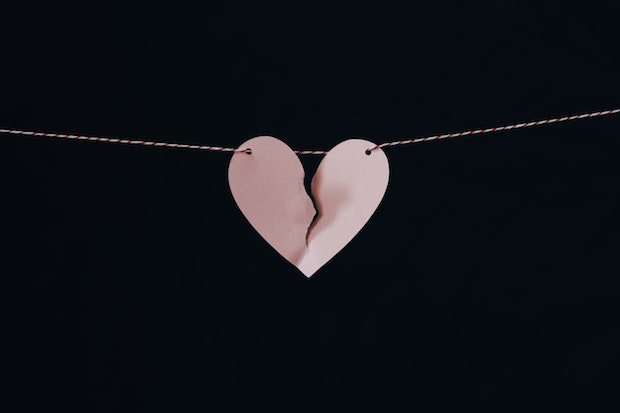 a broken paper heart on a string