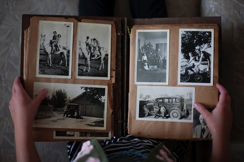 A person looking at an old photograph book