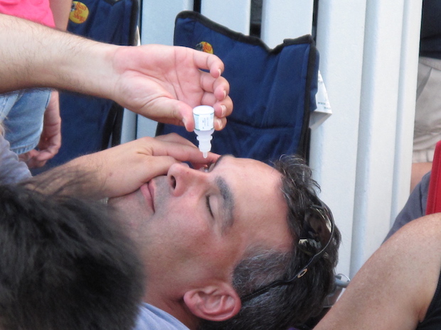 a man administering eye drops