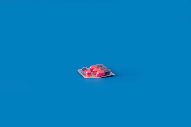 pink pills on a blue background