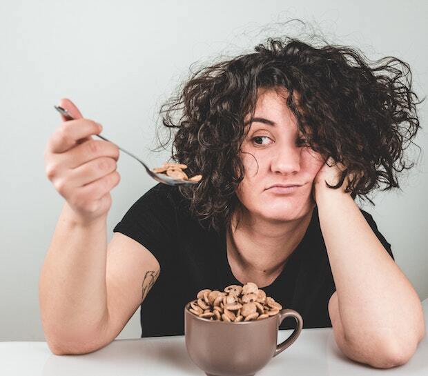 a woman eating a bowl of Cookie Crisps