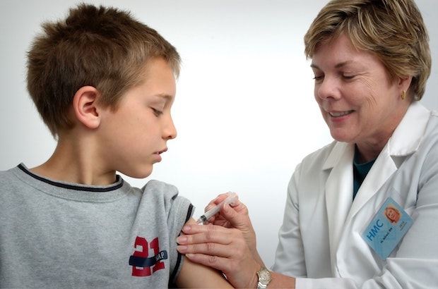 a doctor giving a child a vaccine